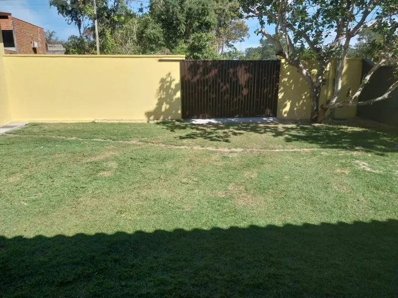 Quintal gramado com portão de acesso na casa em Itacaiú